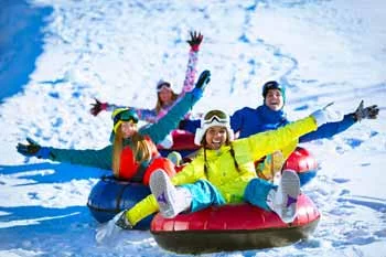 group of friends snow tubing